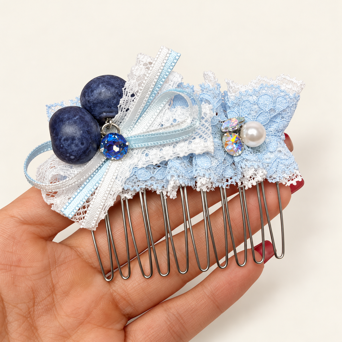 Pale blue and white lace bow hair comb with blueberry charms and decorative beads