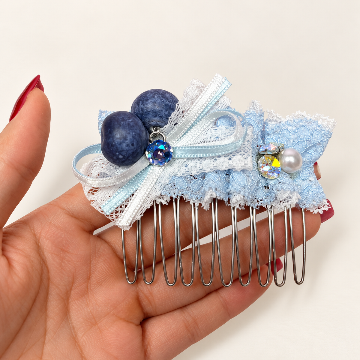 Pale blue and white lace bow hair comb with blueberry charms and decorative beads