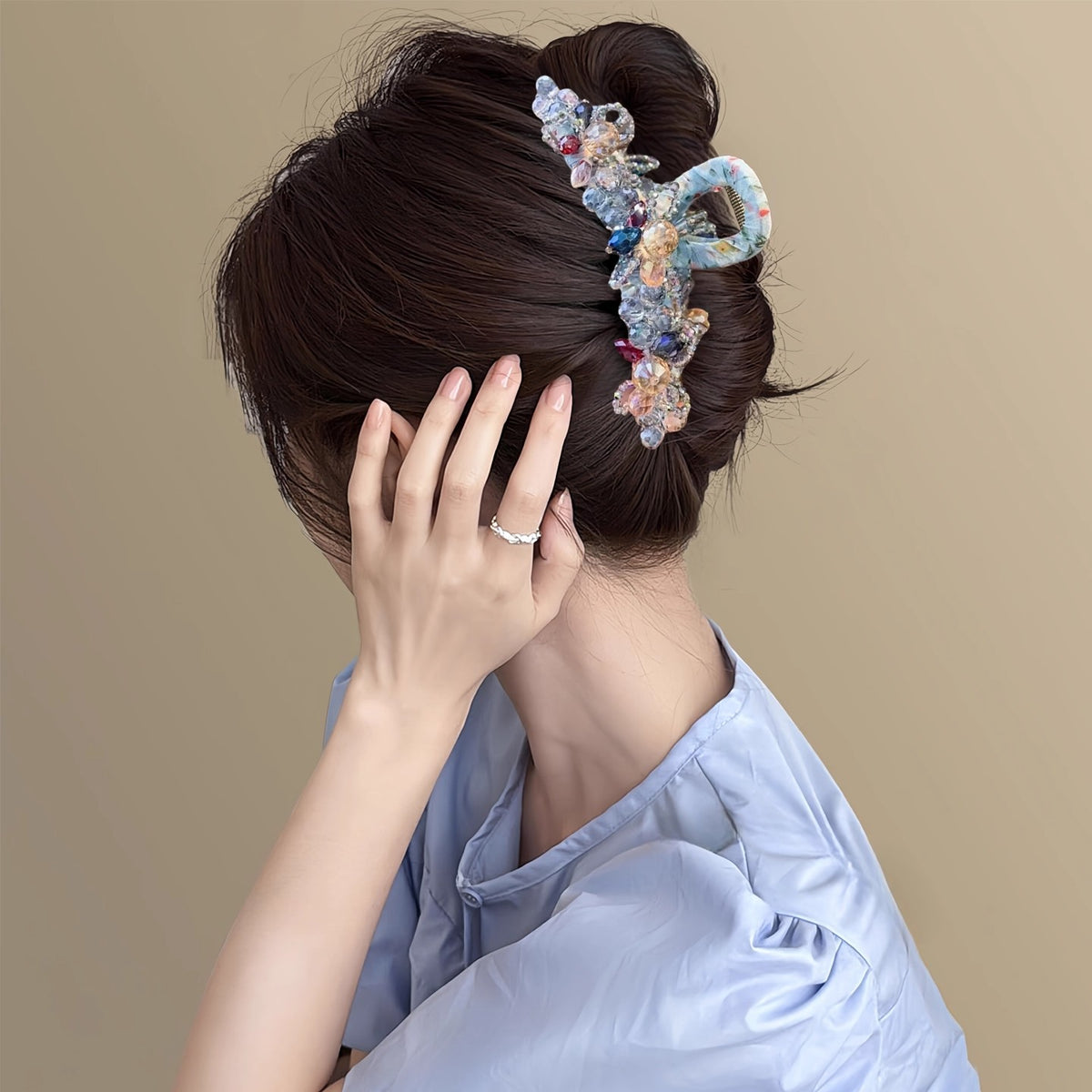 Pastel crystal hair claw styled in an elegant updo