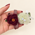 Handmade burgundy yarn flower and sheer ivory flower hair clip with striped ribbon and pearl-style bead