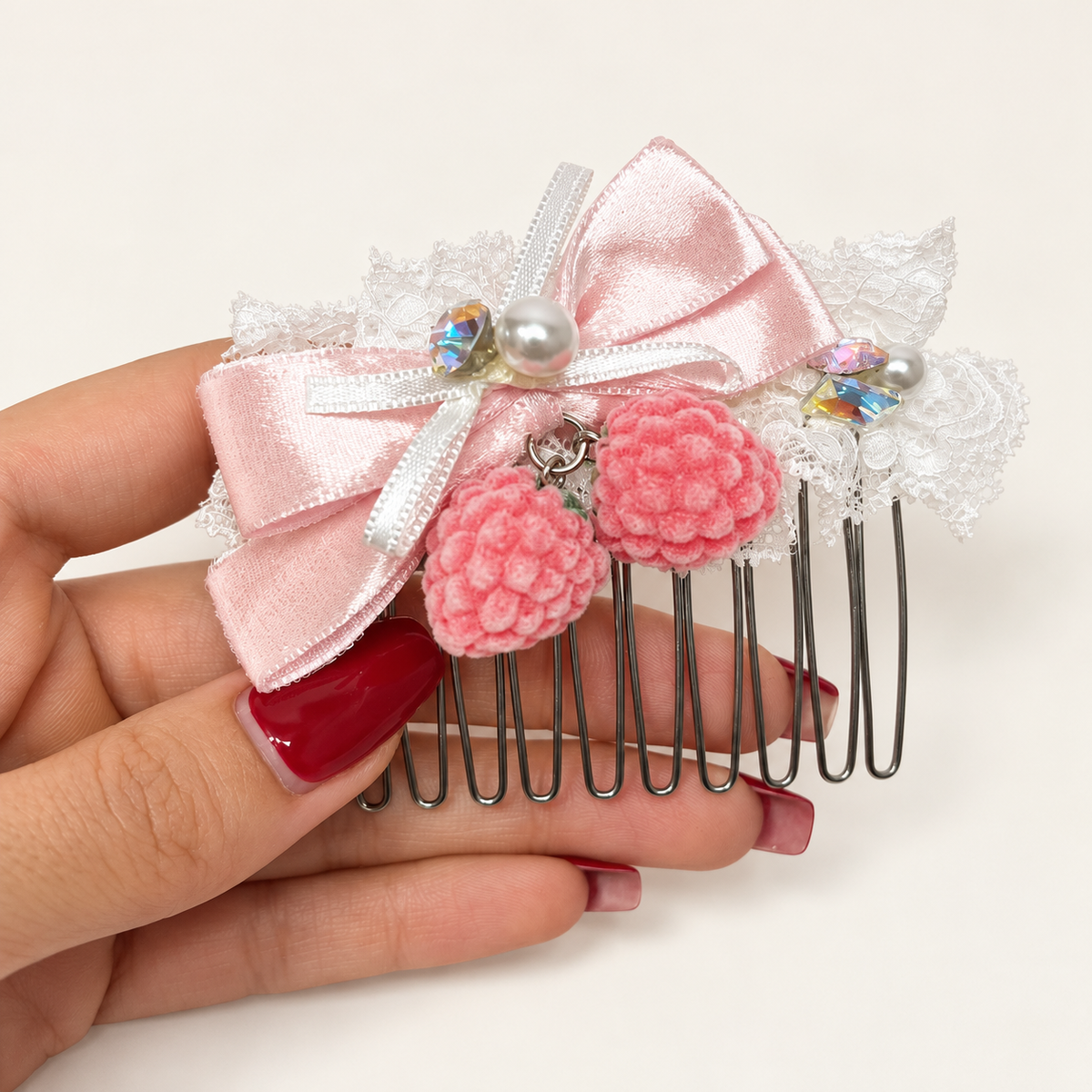 Pink berry lace hair comb with light-pink silvery ribbon bow and pearl-style accents