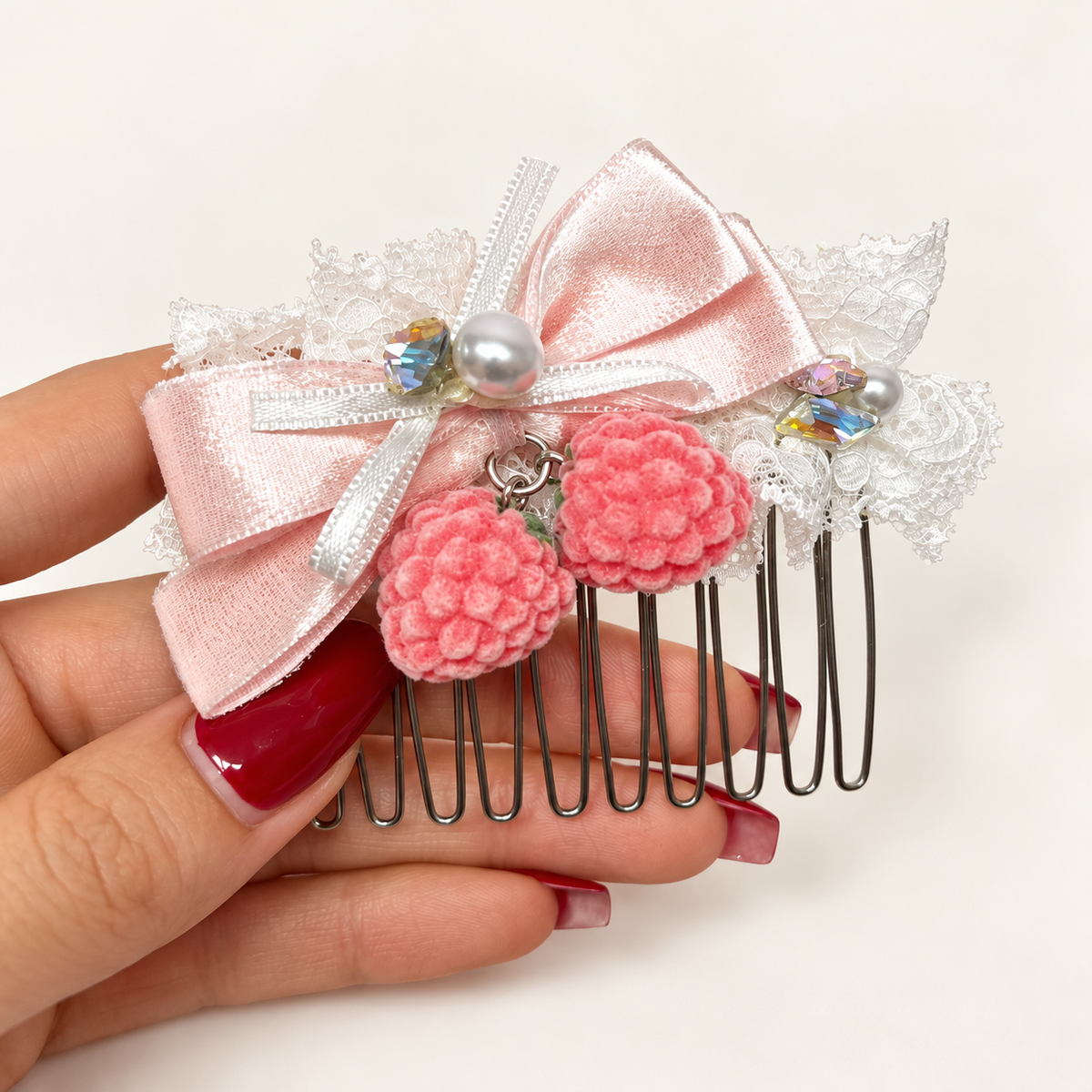 Pink berry lace hair comb with light-pink silvery ribbon bow and pearl-style accents