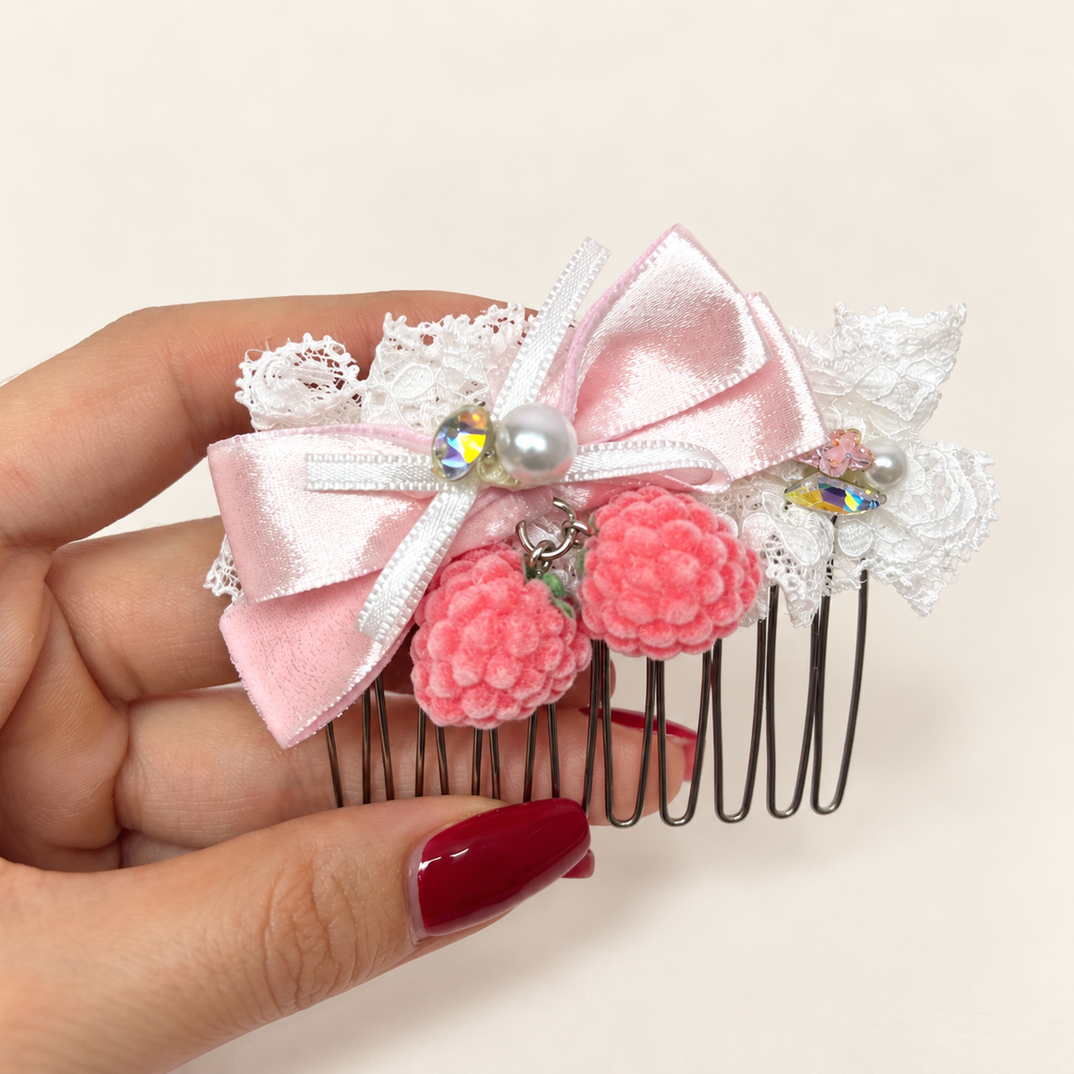 Pink berry lace hair comb with light-pink silvery ribbon bow and pearl-style accents