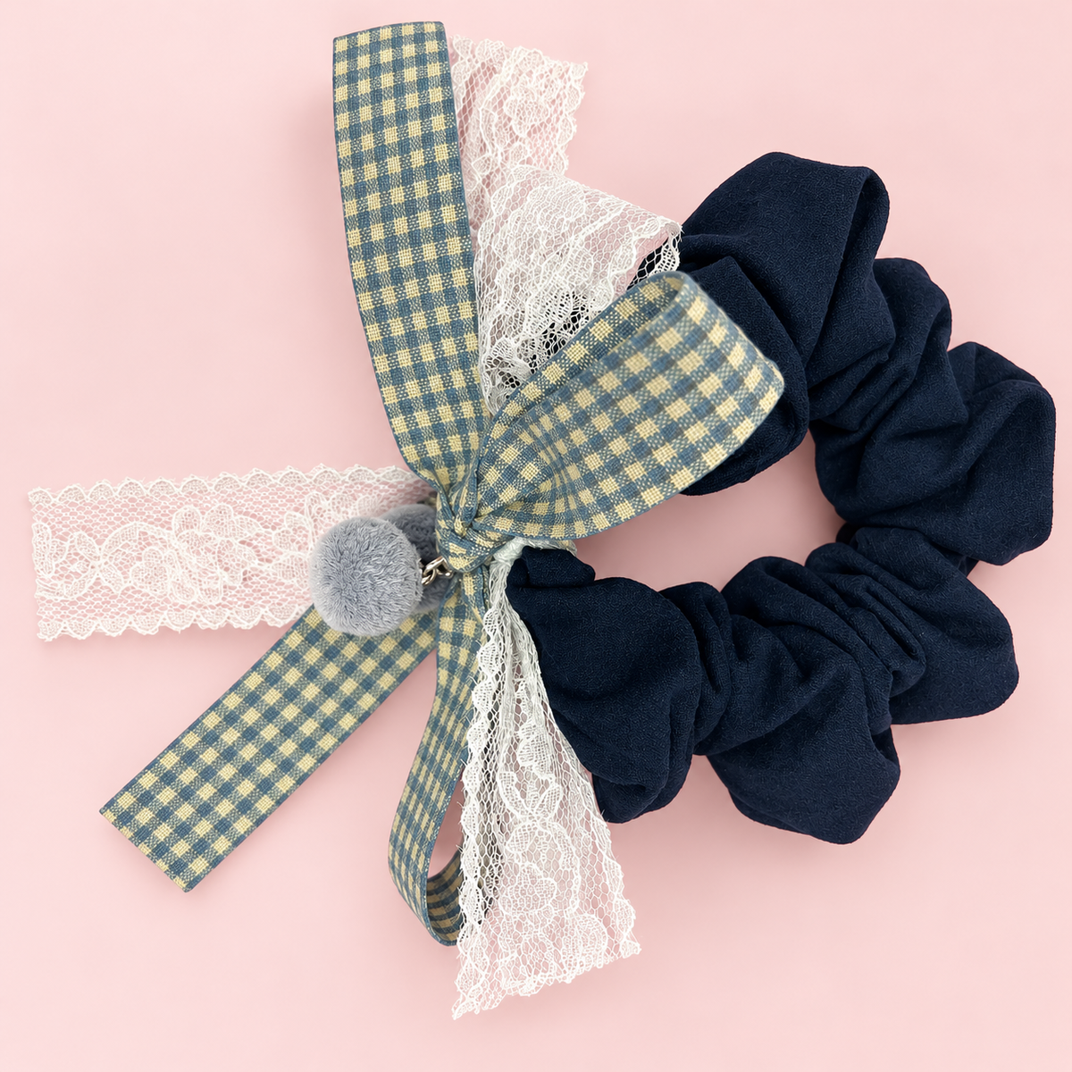 Navy fabric scrunchie with gingham bow, white lace and gray pom pom charms