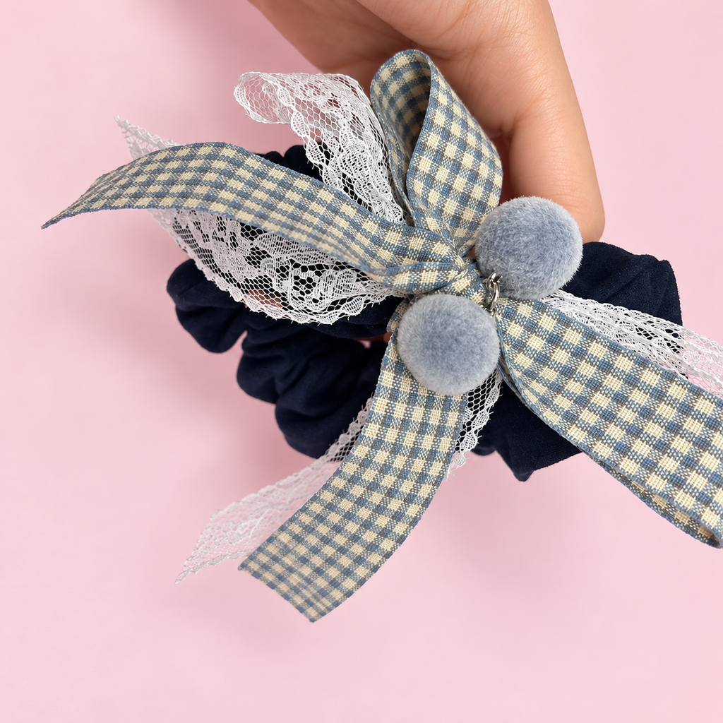 Navy fabric scrunchie with gingham bow, white lace and gray pom pom charms