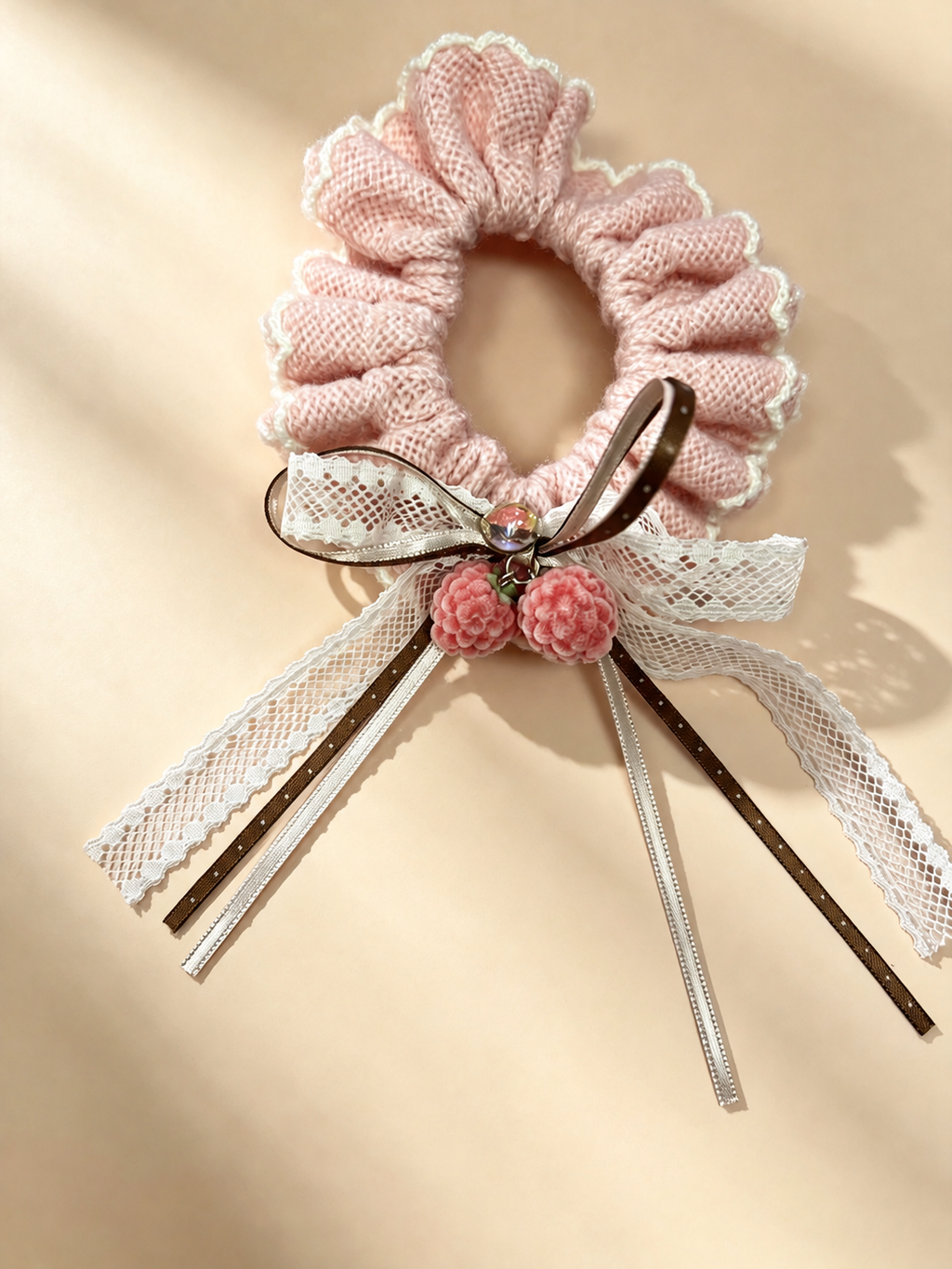 Pink lace bow scrunchie with brown ribbons and two berry charms - view 1
