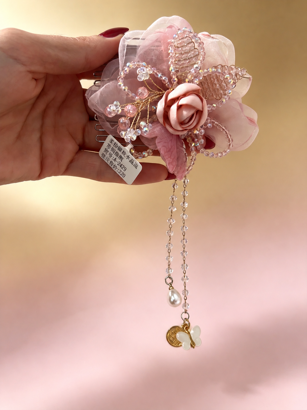 Pink butterfly hair comb front view with dangling chains